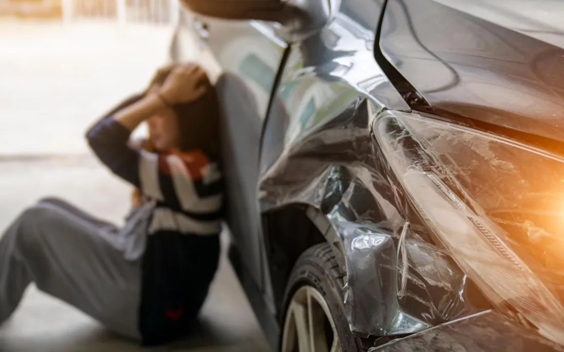 car accident scene with damaged car and injured driver NYC