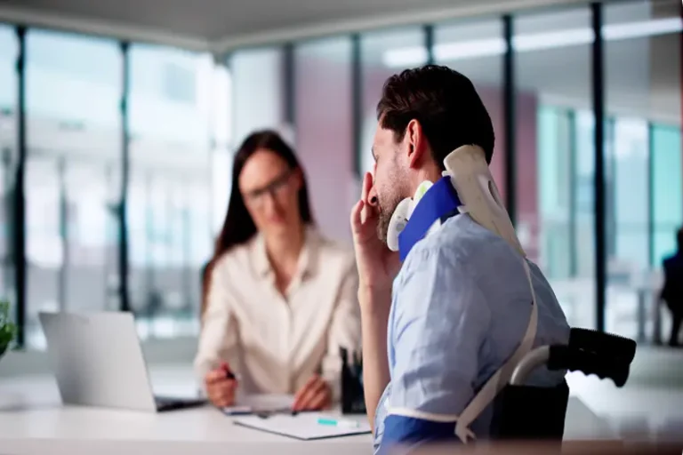 personal injury lawyer NYC consulting injured client with neck brace
