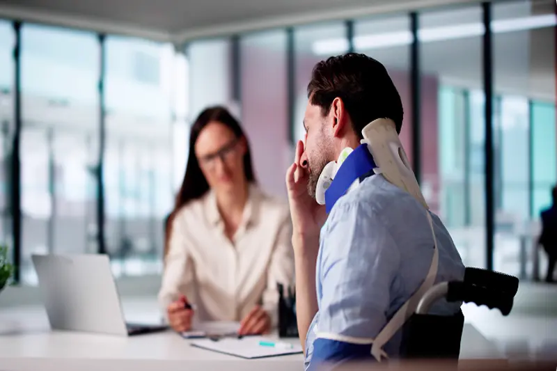 personal injury lawyer NYC consulting injured client with neck brace