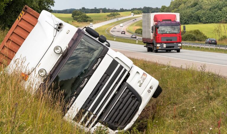 Overturned tractor-trailer on the side of a highway after a rollover truck accident