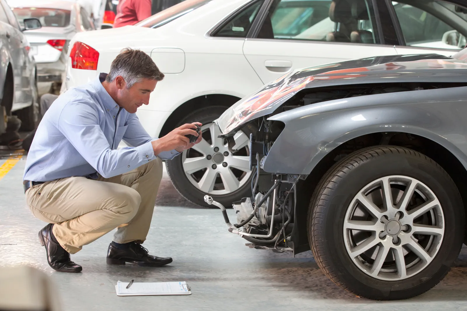 Expert inspecting front-end damage after a crash caused by a defective car part in New York