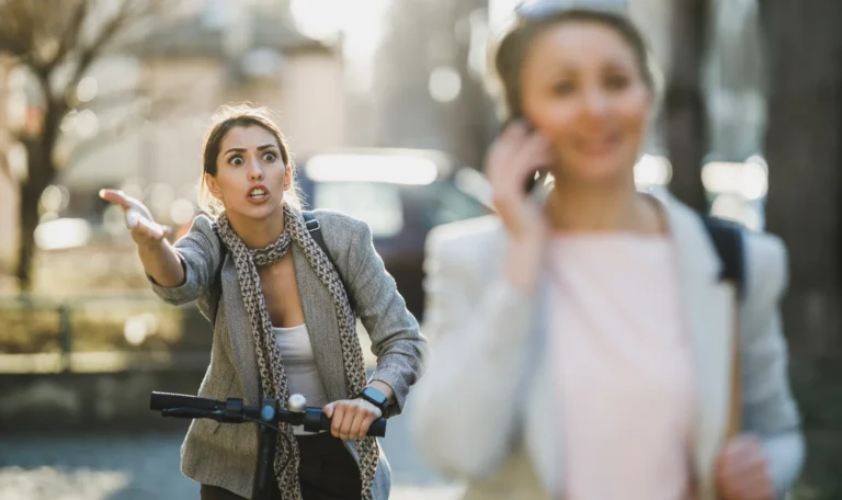 E-scooter rider and pedestrian in a near-collision on an NYC street — the kind of crash a bicycle accident lawyer NYC handles