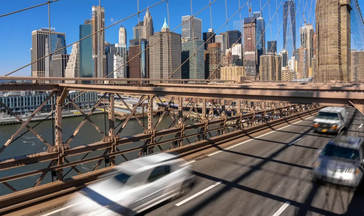 Morning rush hour traffic on the Brooklyn Bridge with the Lower Manhattan skyline in the background