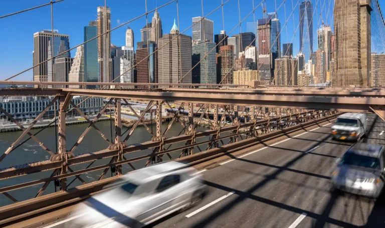 Morning rush hour traffic on the Brooklyn Bridge with the Lower Manhattan skyline in the background